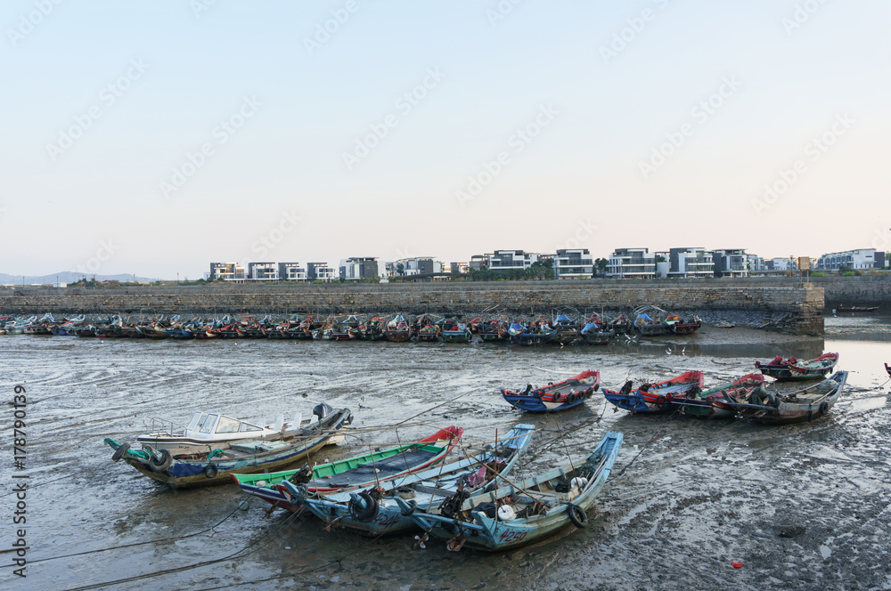 Low tide in harbour, boats be stranded