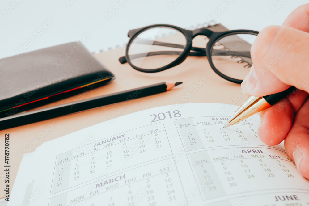 Hand writing blank planning notebook on desk use us organizer schedule life or business planner concept Hand writing blank planning notebook on desk use us organizer schedule life or business planner concept