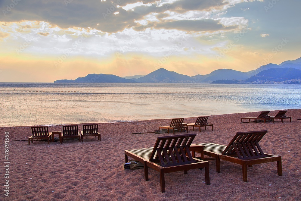 Chairs on sandy beach resort in cape St.Stefan, Montenegro.