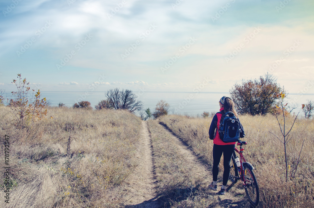 girl with a bike on top of the hill