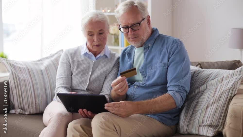 happy senior couple with tablet pc and credit card