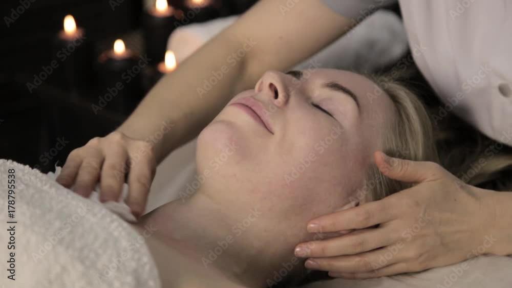 Beautiful woman getting facial massage in spa. facial skin care in beauty saloon.