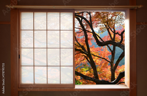 Simple Japanese wood frame window with a nice view of autumn maple leaves