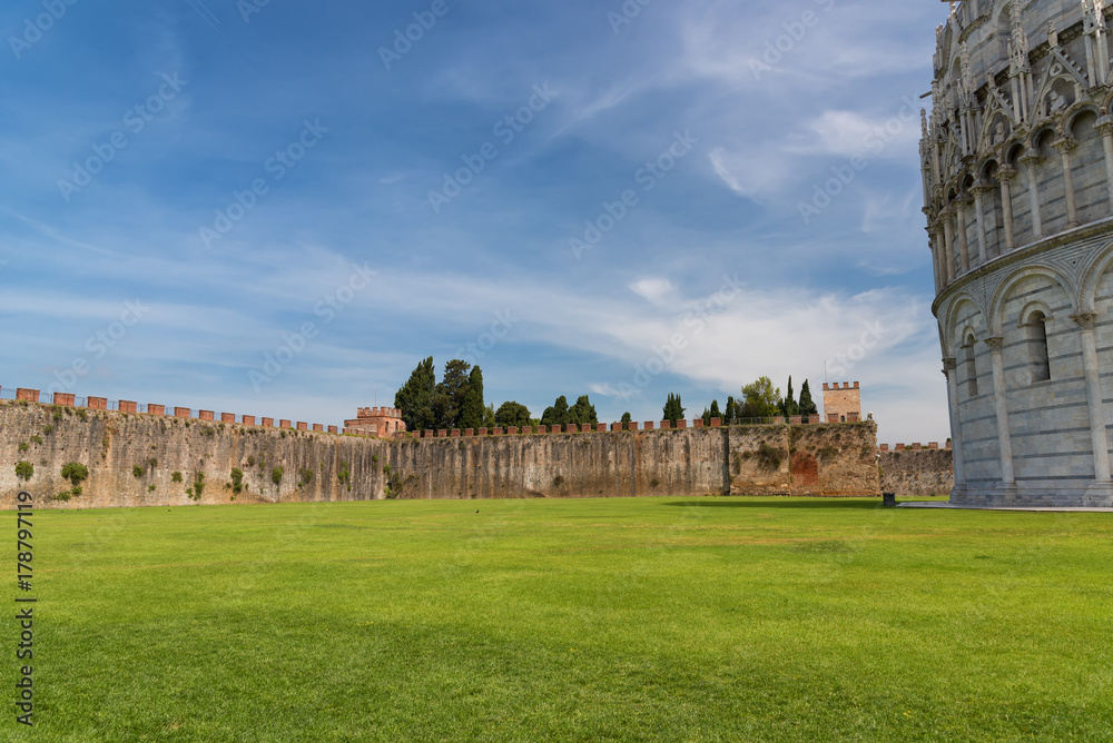 Field of Miracles (Campo dei Miracoli) next to the walls behind the Baptistery of St. John (Battistero) in Pisa, Tuscany, Italy
