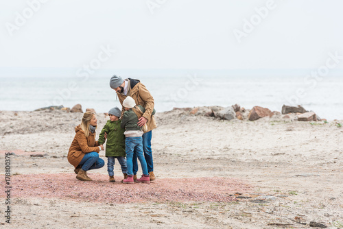 family emracing on seashore