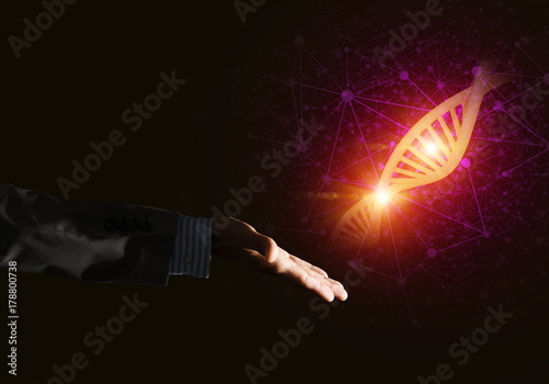 Science medicine and technology concepts as DNA molecule on dark background with connection lines © adam121