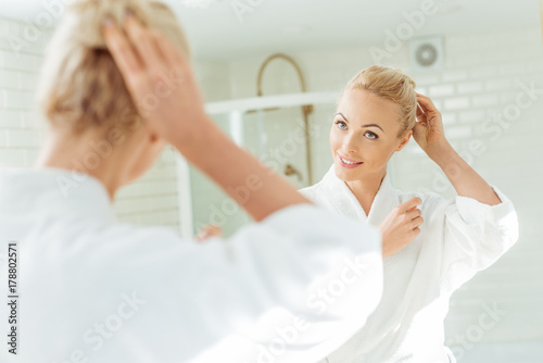 beautiful woman looking at mirror