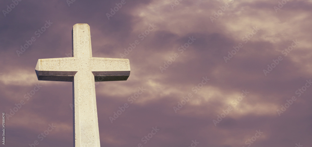 Kreuz vor wolkigem Himmel