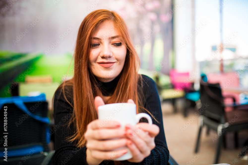 Beautiful girl drinking coffee at the coffee shop Beautiful girl drinking coffee at the coffee shop
