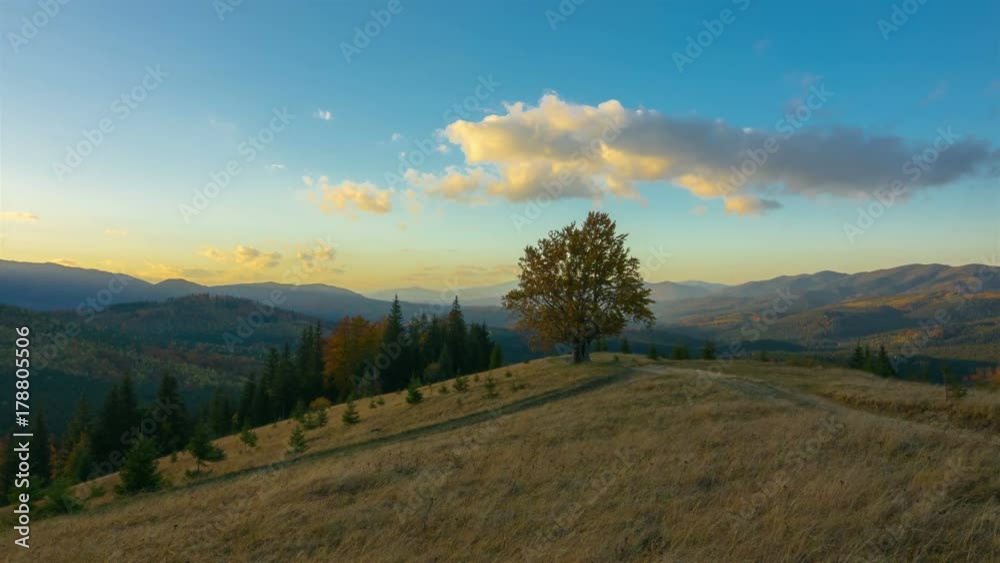Autumn. Sunset Sky in the Mountains with a Lone Tree and Dirt Road in the Foreground and Clouds in the Background. Timelapse. 4K.
Autumn. Sunset Sky in the Mountains with a Lone Tree and Dirt Road in the Foreground and Clouds in the Background. Timelapse. 4K.