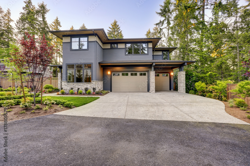 New construction home with wood and stone siding New construction home with wood and stone siding