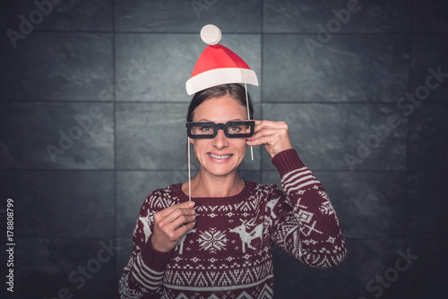 Women wearing paper santa hat and eyeglasses