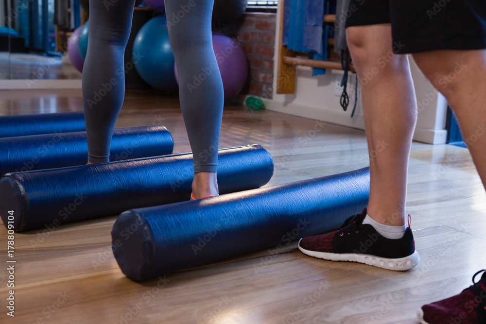 Physiotherapist assisting senior woman in performing exercise on Physiotherapist assisting senior woman in performing exercise on