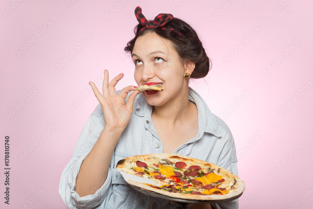 happy woman presents pizza on pink background happy woman presents pizza on pink background