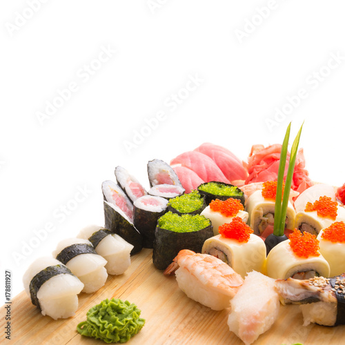 Sushi rolls served on a wooden plate in a restaurant