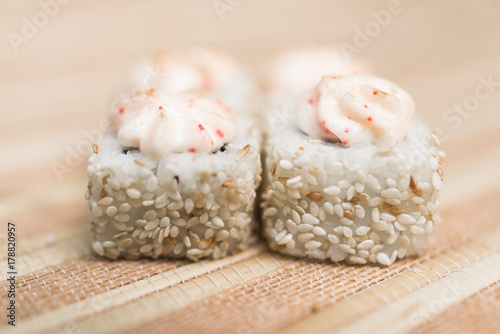 Sushi rolls with sesame and sauce close-up in defocus 2