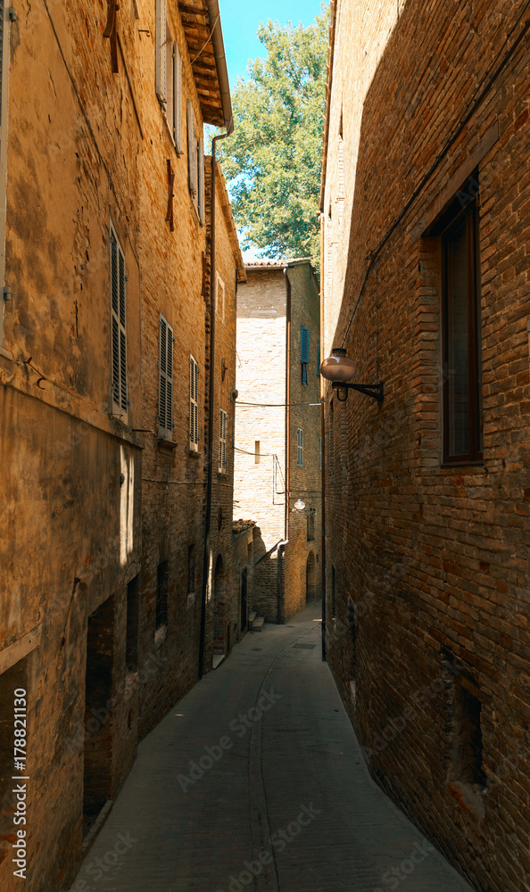 Urbino, Italy - August 9, 2017: A small street in the old town of Urbino. sunny day.