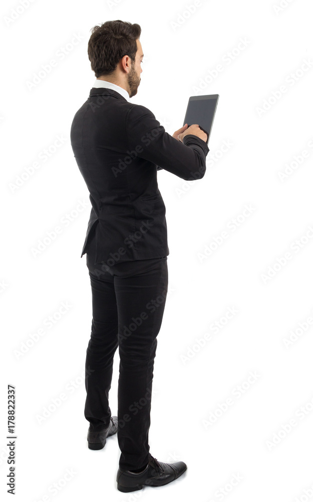 Entrepreneur on the back using a tablet. Beautiful and elegant person is wearing black suit.. Entrepreneur on the back using a tablet. Beautiful and elegant person is wearing black suit..