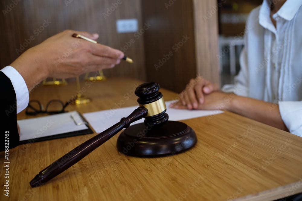 Legal counsel presents to the client a signed contract with gavel and legal law. justice and lawyer concept. Legal counsel presents to the client a signed contract with gavel and legal law. justice and lawyer concept.