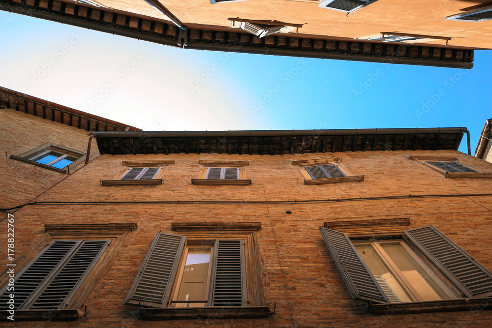 Urbino, Italy - August 9, 2017: architectural elements of a building in the old town of Urbino. Urbino, Italy - August 9, 2017: architectural elements of a building in the old town of Urbino.