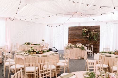 Wedding decorated restaurant in light colors and rustic style