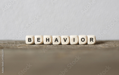Word BEHAVIOR made with wood building blocks