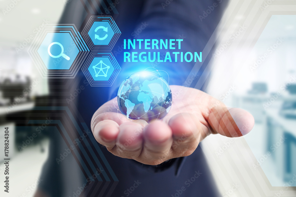 The concept of business, technology, the Internet and the network. A young entrepreneur working on a virtual screen of the future and sees the inscription: Internet regulation The concept of business, technology, the Internet and the network. A young entrepreneur working on a virtual screen of the future and sees the inscription: Internet regulation