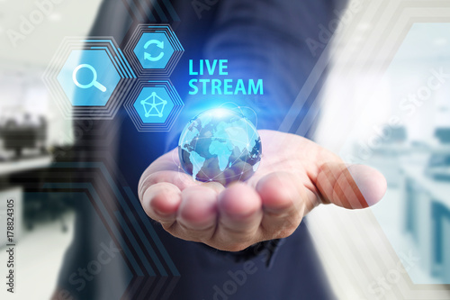 The concept of business, technology, the Internet and the network. A young entrepreneur working on a virtual screen of the future and sees the inscription: Live stream