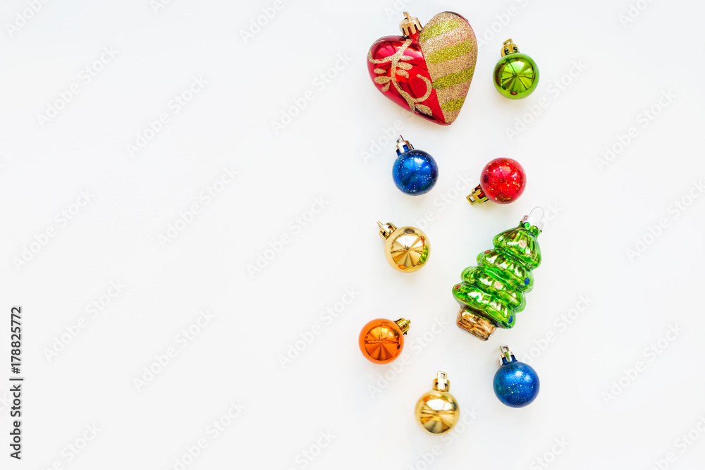 Obraz premium Christmas background with decorations. New Year symbol - fir tree. Shiny colorful balls and red heart. Flat lay, top view. Place for text.
