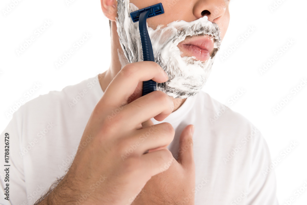 man shaving with razor