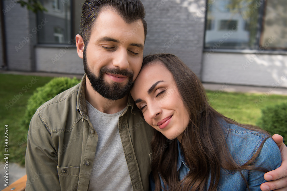 couple hugging with closed eyes couple hugging with closed eyes