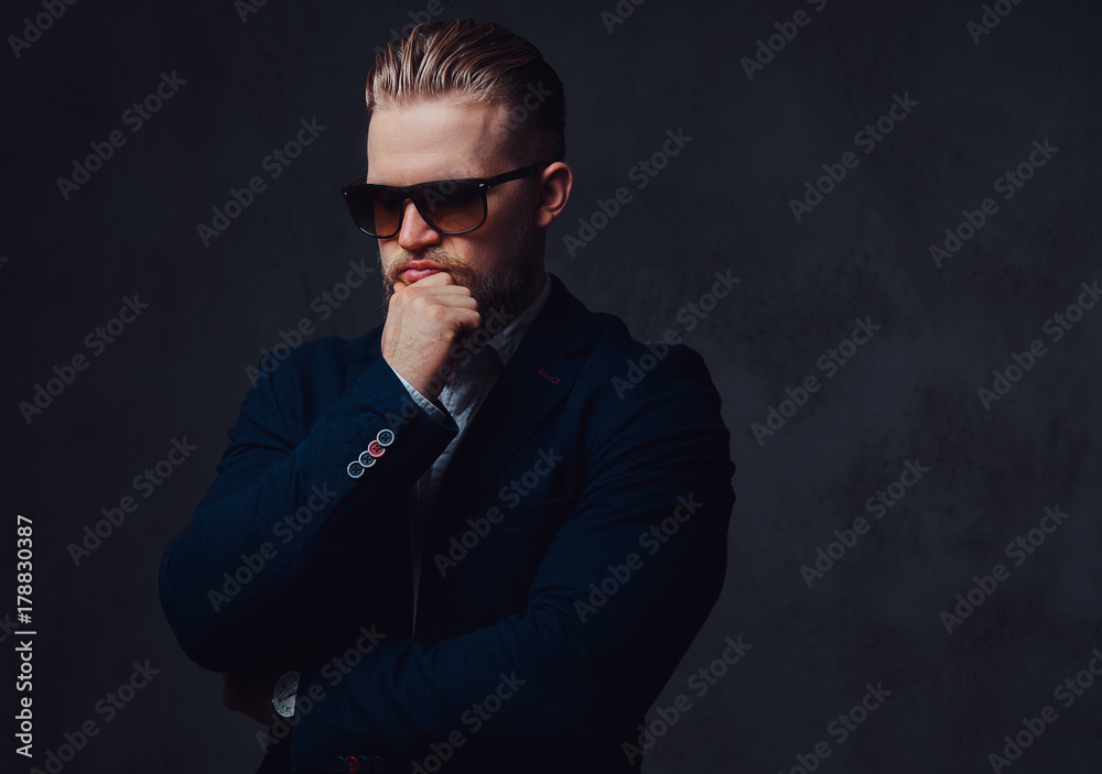 A man dressed in a suit and sunglasses. A man dressed in a suit and sunglasses.