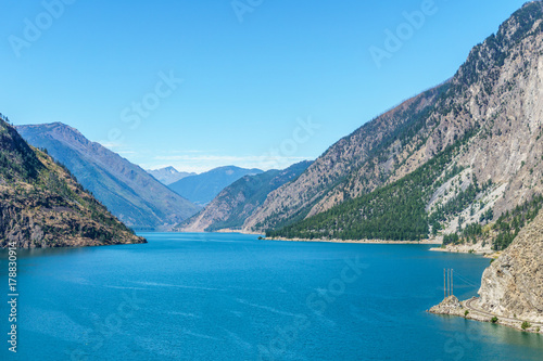 Seton lake near Lillooet British Columbia Canada high mountains with blue sky.