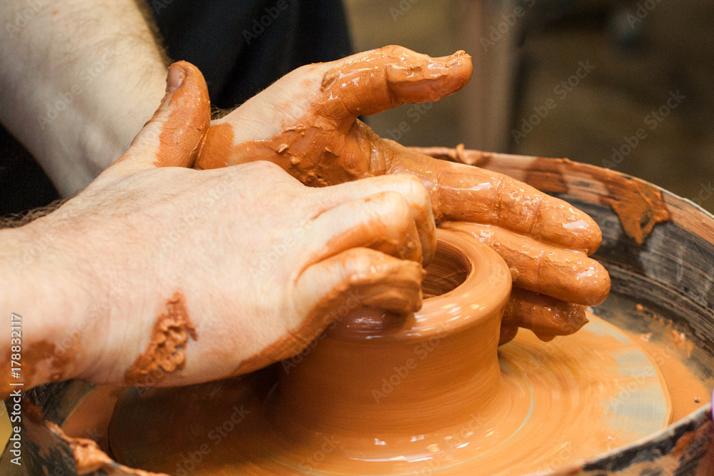 In the pottery workshop. The hands of the teacher who teach pottery