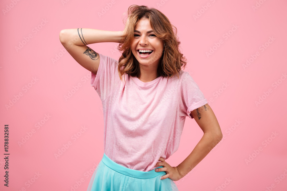 Cheerful young woman isolated over pink background posing Cheerful young woman isolated over pink background posing