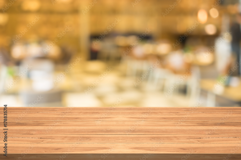 Empty wood table top on blurred background at coffee shop,copyspace for montage your products
