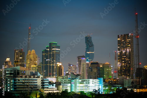 Urban city twilight with sky scrapers and telecommunication tower.