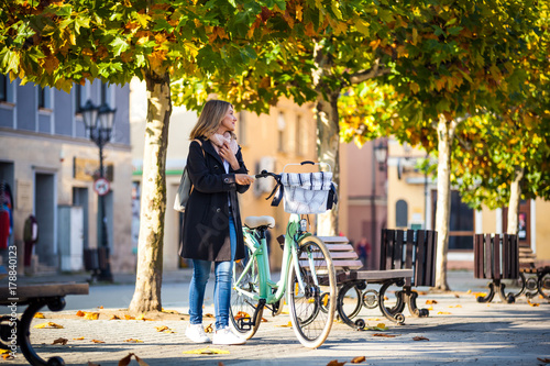 Wallpaper Mural Girl in coat with retro bike on the autumn street Torontodigital.ca