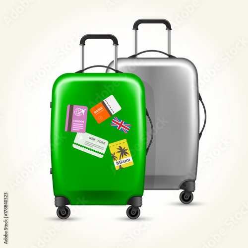 Wheeled suitcases with travel tags - silver and green baggage