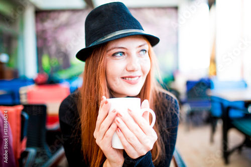 Beautiful girl drinking coffee at the coffee shop