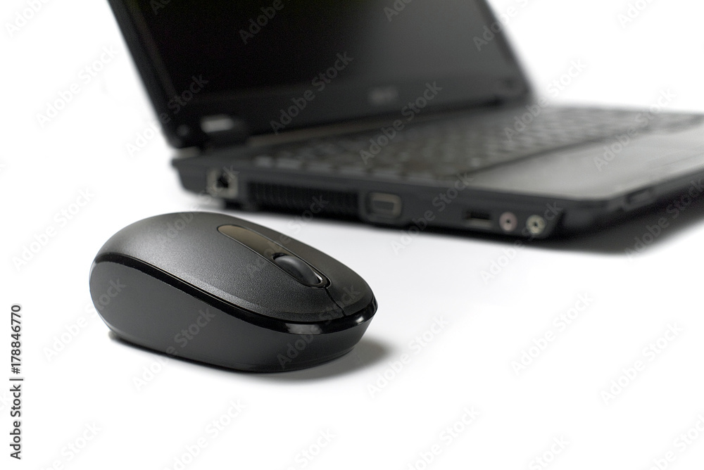 wireless mouse in front of laptop on white background wireless mouse in front of laptop on white background