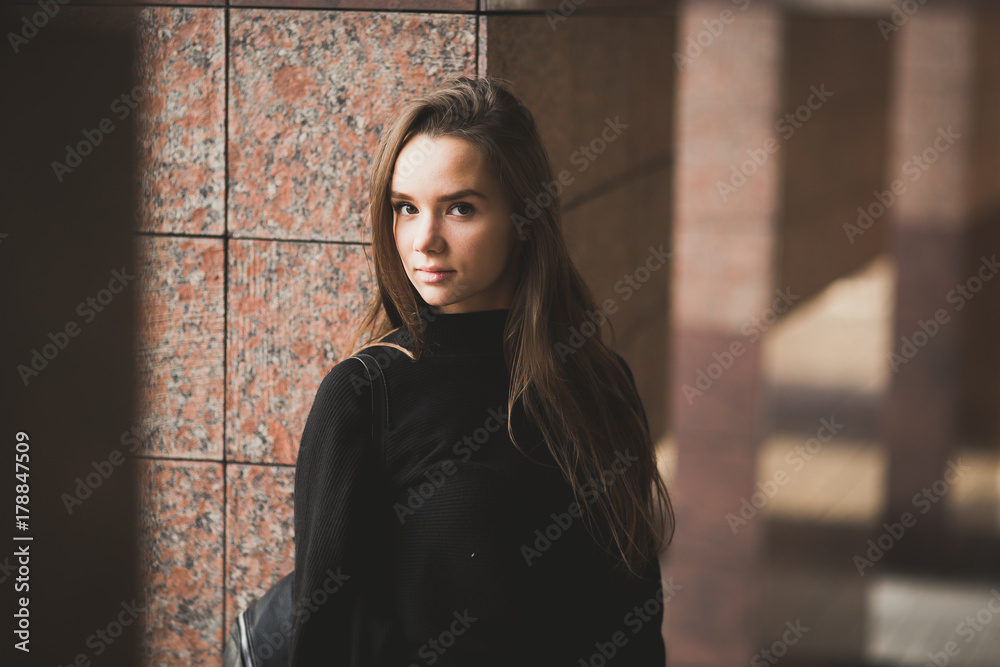 Beautiful young woman posing on the street in old city Beautiful young woman posing on the street in old city