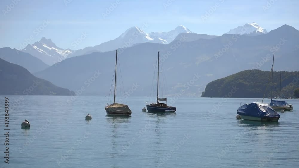 Boats floating on lake Thun Bernese Oberland Switzerland Boats floating on lake Thun Bernese Oberland Switzerland