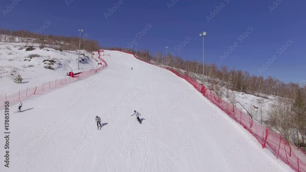 AERIAL: Two beginners of the skier learn to move down the ski slope. Ski resort in the wild mountains, frozen winter, aerial footage. AERIAL: Two beginners of the skier learn to move down the ski slope. Ski resort in the wild mountains, frozen winter, aerial footage.
