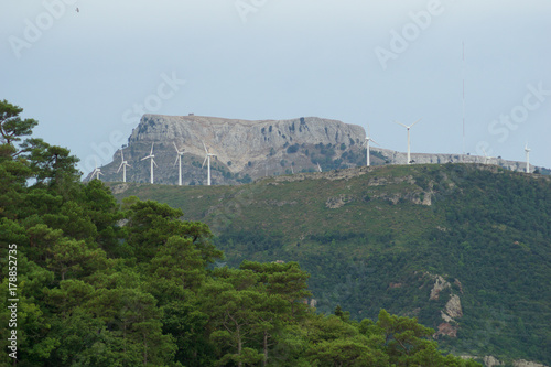 TARRAGONA, SPAIN - AUG 29th, 2017: A wind farm, group of Small wind turbine in the same location used to produce electricity in Catalonia photo