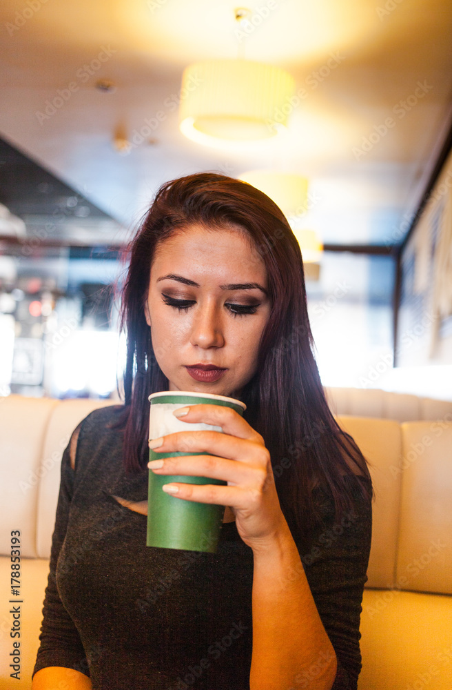 Beautiful girl drinking coffee at the coffee shop Beautiful girl drinking coffee at the coffee shop