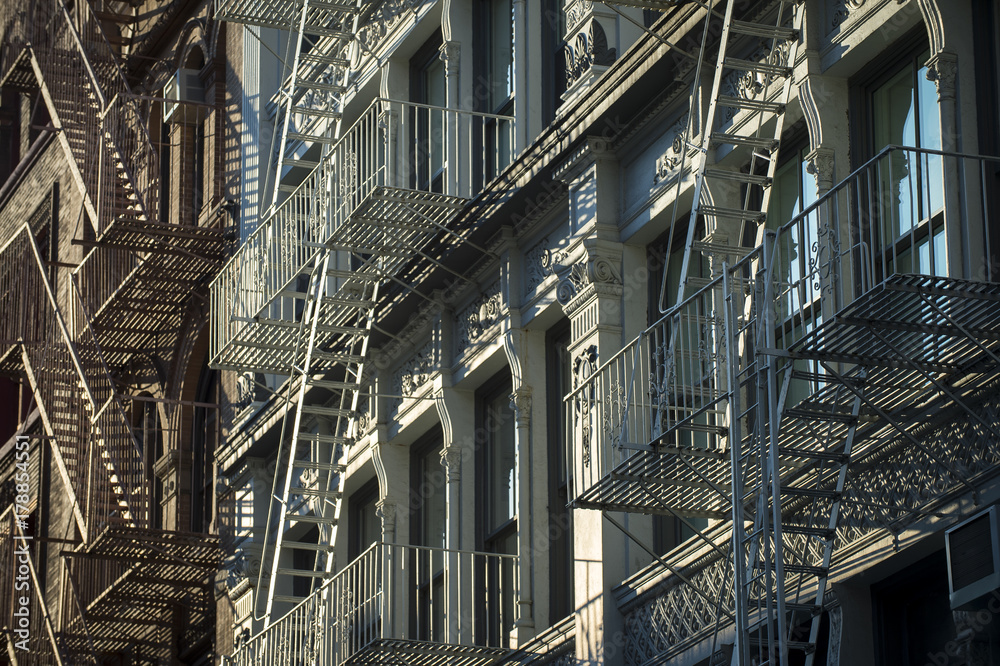 Architectural detail view of cast iron fire escapes in New York City