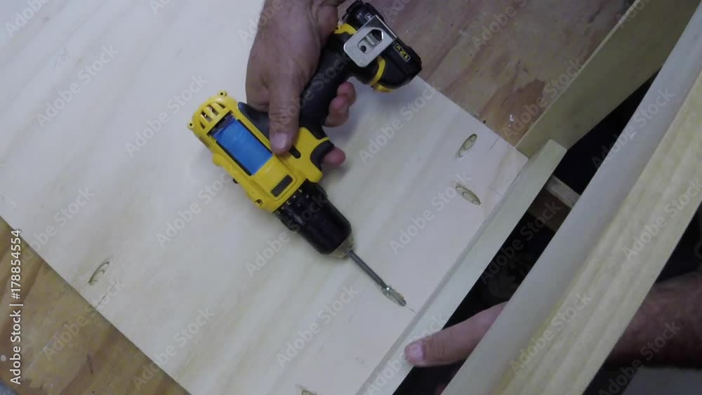 installing pocket hole screws in shelf to secure legs.
