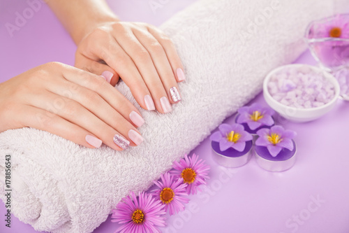 Beautiful pink and silver manicure with flowers and spa essentials © maryviolet