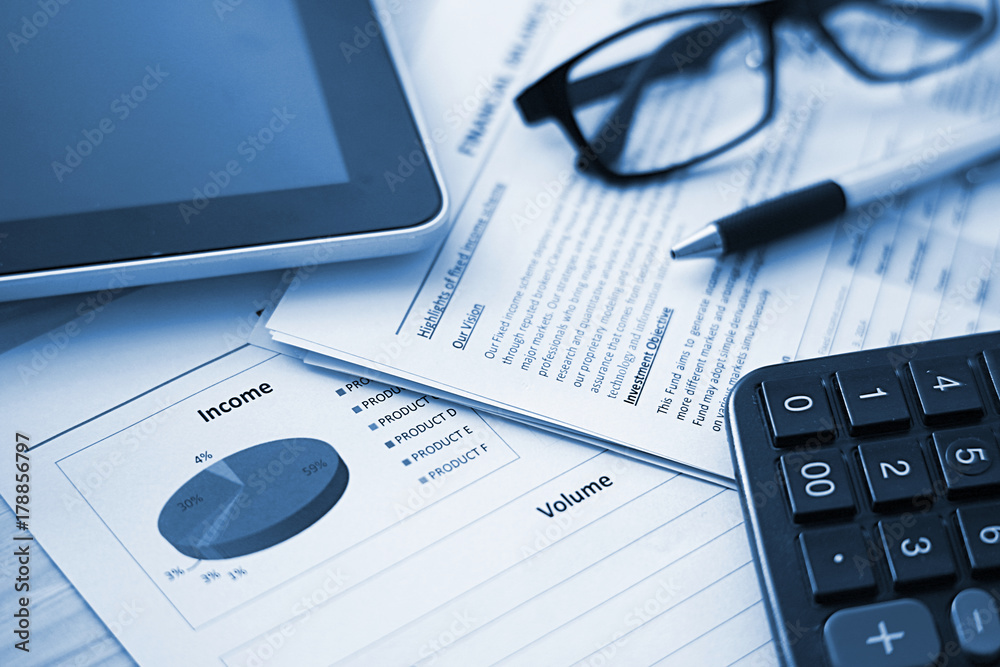 Financial paper and work station with tablet on working table, business concept. Financial paper and work station with tablet on working table, business concept.